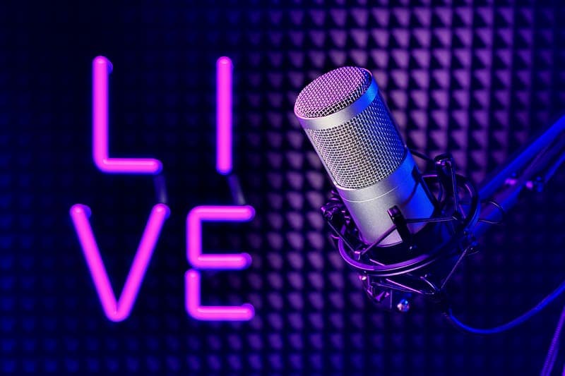 Neon live sign beside a studio microphone